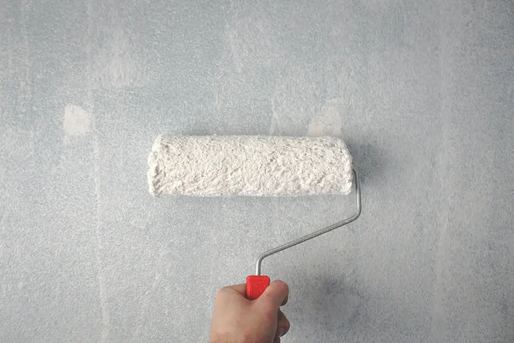a roller being used to apply interior paint